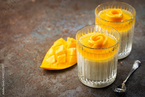 Obraz na płótnie Italian dessert panna cotta with mango in glass on gray background w salonie