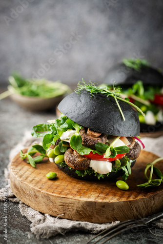 Obraz na płótnie Veggie mushroom, green salad and vegetable black burgers. on gray stone background Copyspace. w salonie