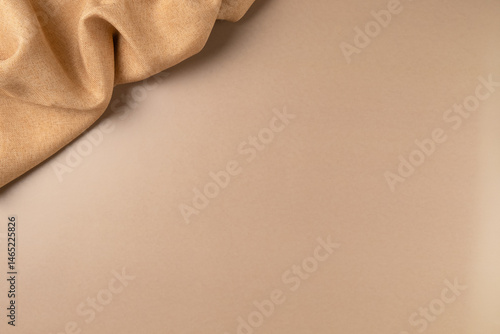 Brown fabric on beige as concept background. Copy space