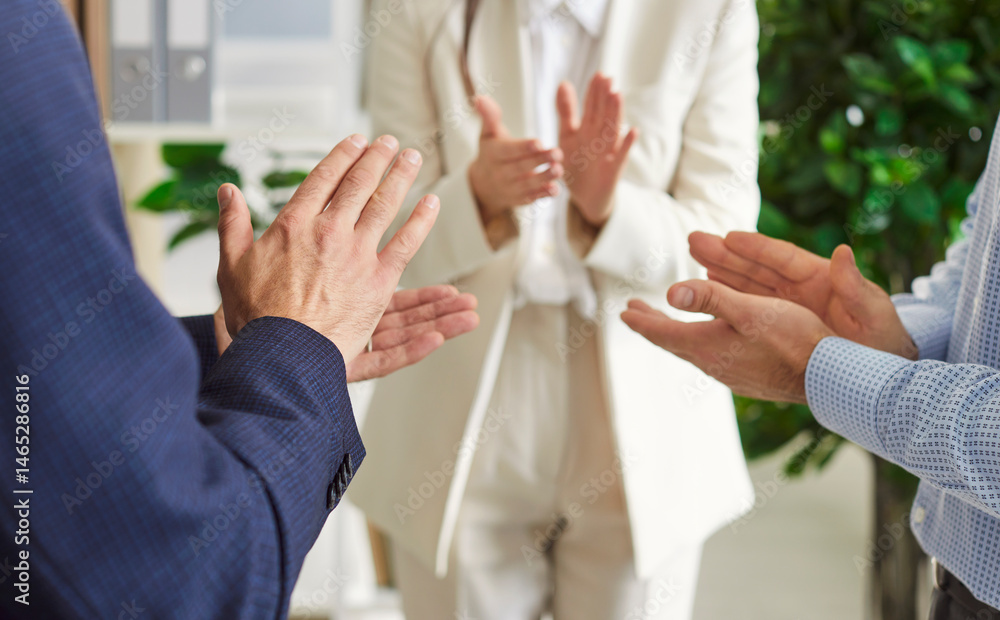 Close up portrait of a group of business people in suits celebrating success in business or making a deal standing in office in circle applauding each other. Successful job and team work concept. Close up portrait of a group of business people in suits celebrating success in business or making a deal standing in office in circle applauding each other. Successful job and team work concept.