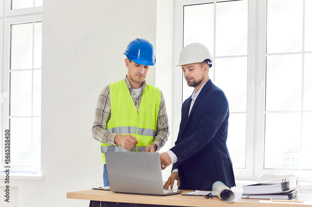 Construction engineer teamwork colleagues meeting looking at project online on laptop, blueprints, planning work, discussion with worker in hardhat, architectural agency manager, interior design ideas Construction engineer teamwork colleagues meeting looking at project online on laptop, blueprints, planning work, discussion with worker in hardhat, architectural agency manager, interior design ideas