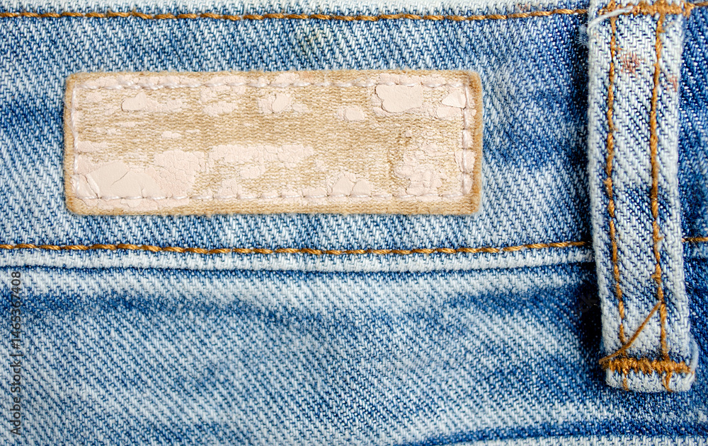 Leather label on the back of blue jeans close-up