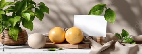 Obraz na płótnie Two vivid oranges rest beside a customizable card on a soft, textured surface, illuminated by natural light with shadows from greenery w salonie