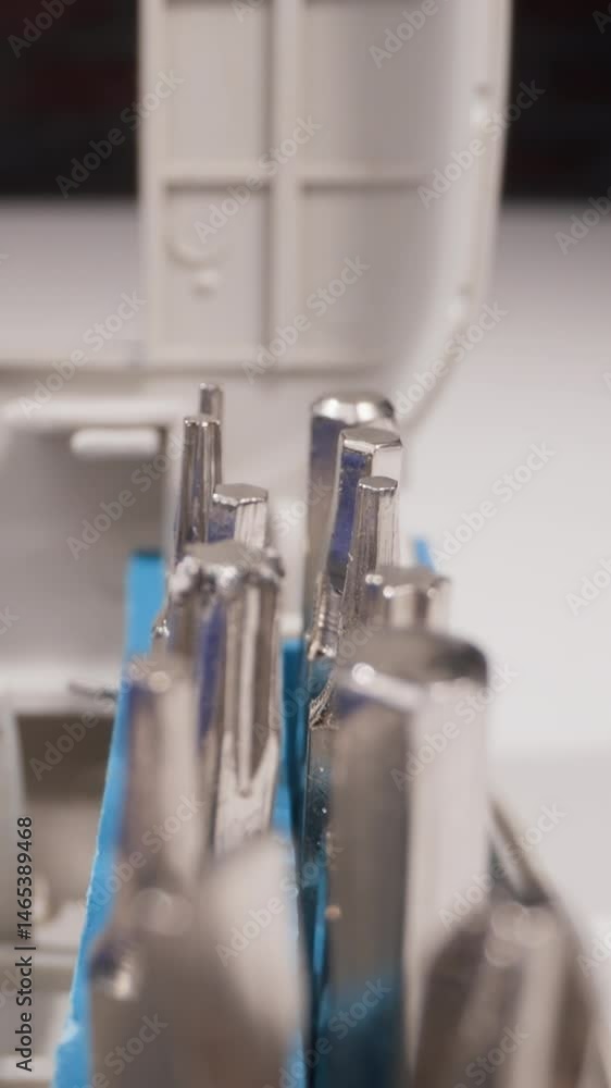 Set of different shaped metal heads for screwdriver in open box on table macro view zoom out. Manual tools kit. Professional handyman supplies Set of different shaped metal heads for screwdriver in open box on table macro view zoom out. Manual tools kit. Professional handyman supplies