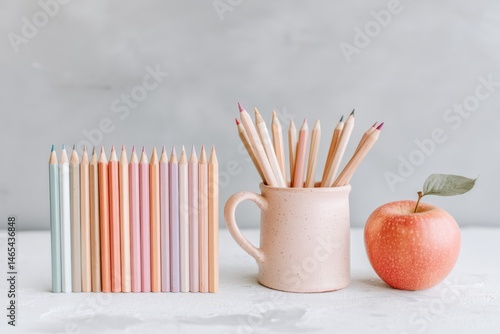 Obraz na płótnie Pencils in Mug With Apple on Table Creating a Creative Workspace Atmosphere w salonie