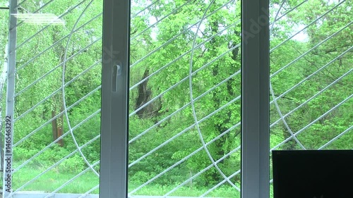Window with a figured lattice on the wall of an old half-abandoned house.