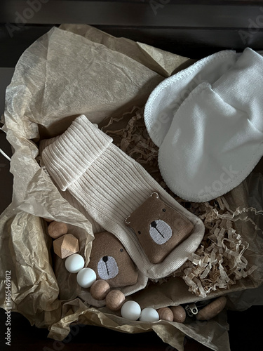 Obraz na płótnie Socks, white scratches, a rodent elephant, beads. A set of accessories and toys for newborns in a pull-out shelf in the bedside table w salonie