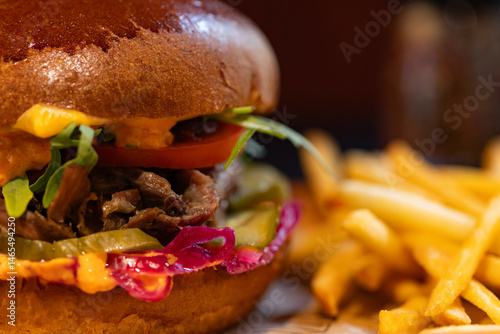 Closeup of hamburger and fries served at restaurant