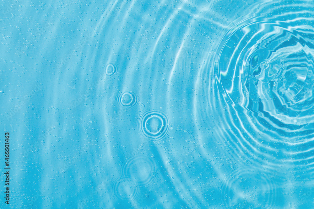 drops on water with circles on a blue background