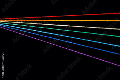 Obraz na płótnie multicolored sewing threads in the form of a rainbow on a black background w salonie