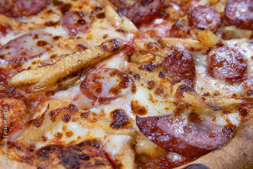 Close-up of Sausage Pizza with Extra Cheese and French Fries Close-up of Sausage Pizza with Extra Cheese and French Fries
