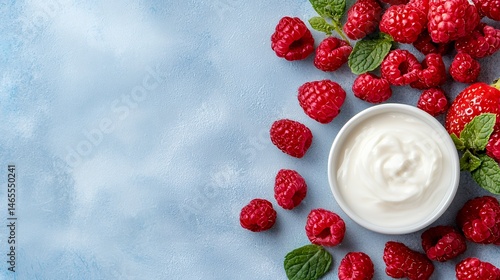 Raspberries and Yogurt on a Light Blue Background for Healthy Eating