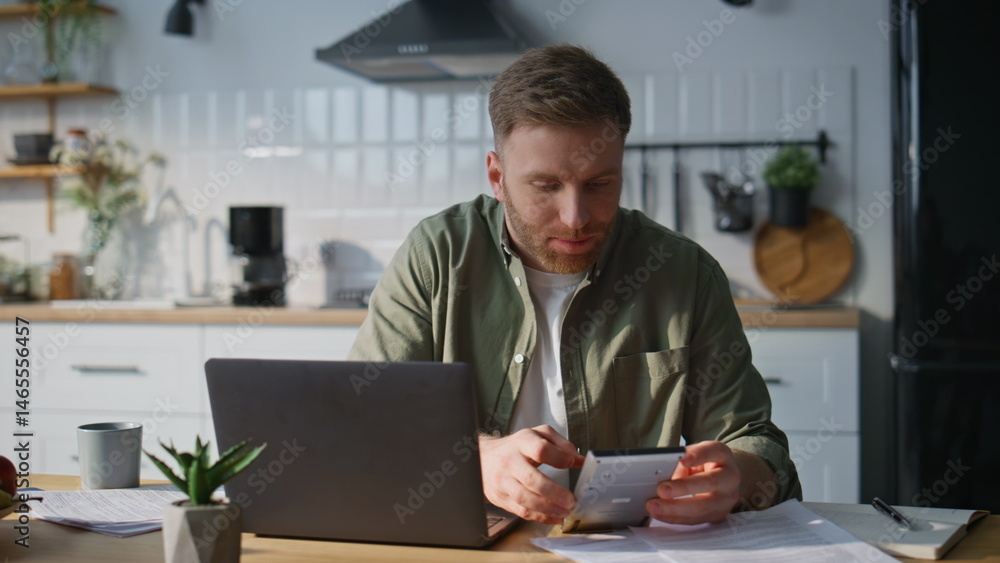 Man accountant using calculator at home office closeup. Manager working laptop