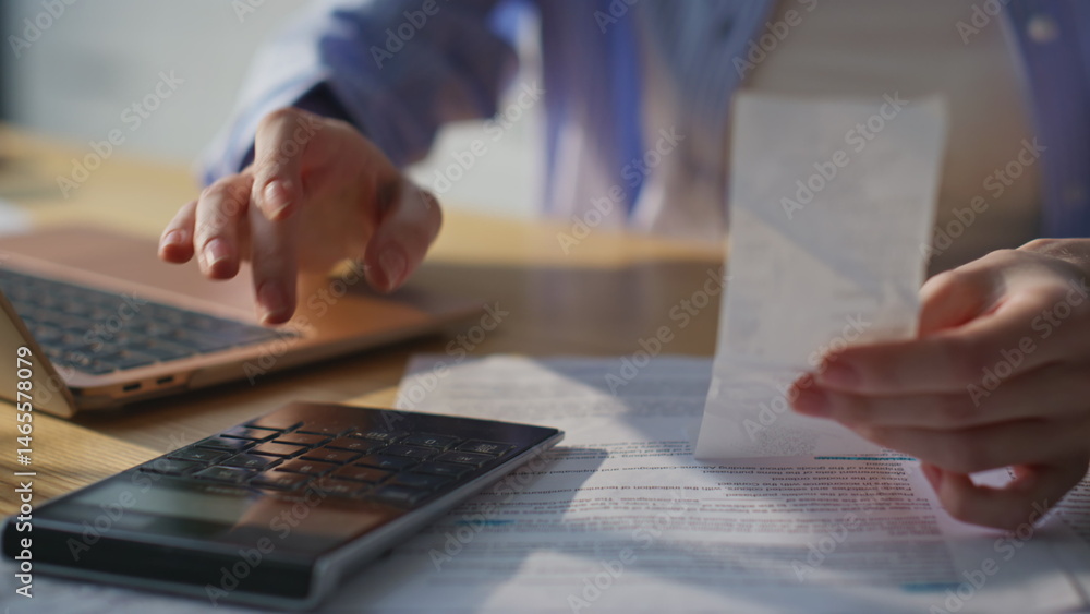 Bookkeeper hands calculating financial documents in home office closeup.