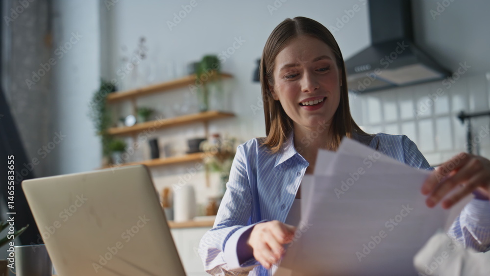 Smiling online teacher talking to laptop webcam at home kitchen closeup.
