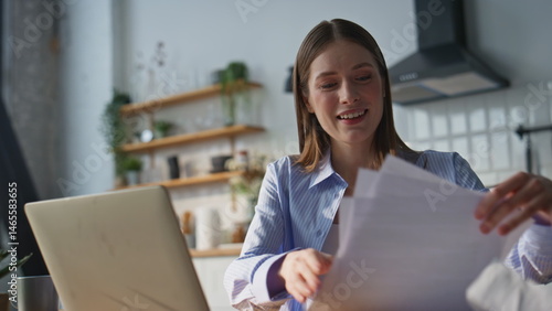 Smiling online teacher talking to laptop webcam at home kitchen closeup. 