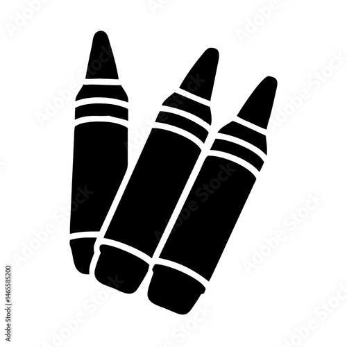 Three black crayons aligned together, ready to create colorful artwork and designs