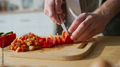 Unknown man slicing vegetables on chopping board home kitchen closeup. Guy hands