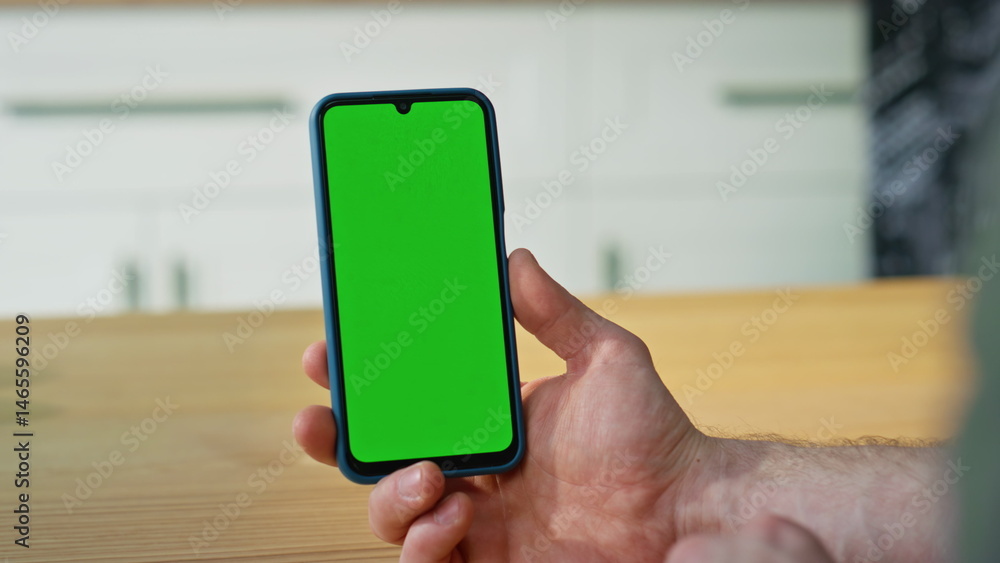 Finger touching mockup cellphone touchscreen turning application at home closeup