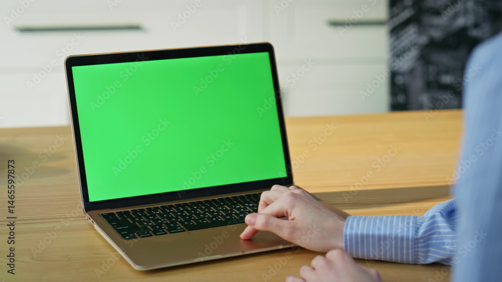 Hands using touchpad chroma key laptop surfing online at home apartment closeup.