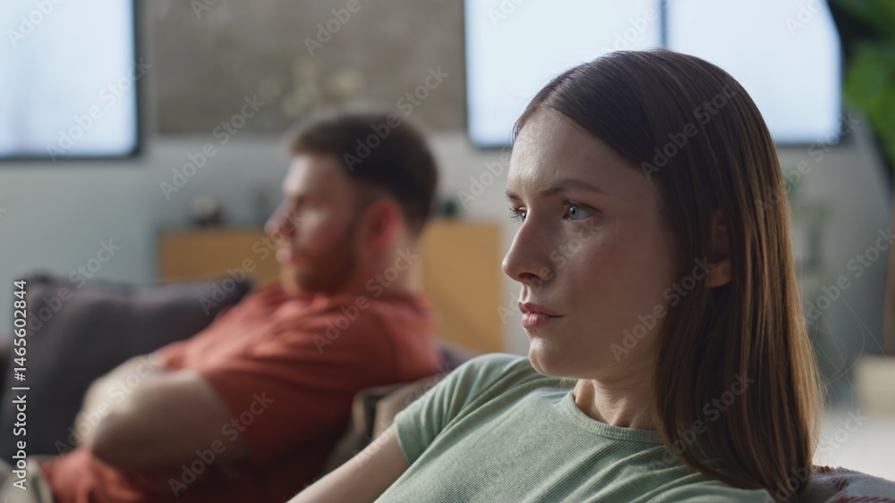 Upset wife offended husband showing dissatisfaction at home sofa closeup.