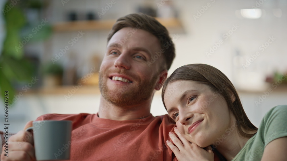 Bonding couple resting couch enjoying tenderness closeup. Smiling husband wife