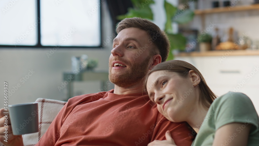 Romantic pair relaxing couch with coffee mugs closeup. Loving woman resting man
