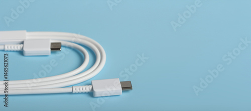 Obraz na płótnie White USB Type-C charging cable on light blue surface with copy space w salonie