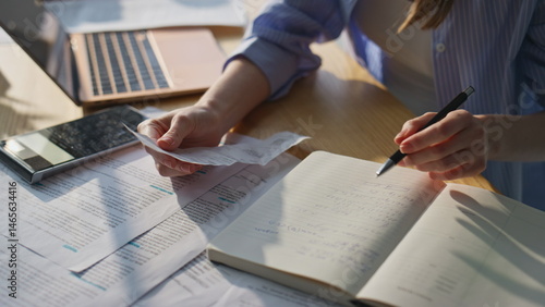 Obraz na płótnie Woman hands calculating finances expenditures checking notes in notebook closeup w salonie