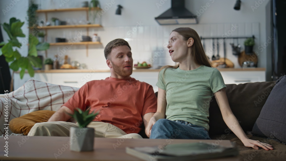 Couple having casual conversation sitting home couch. Relaxed man woman talking