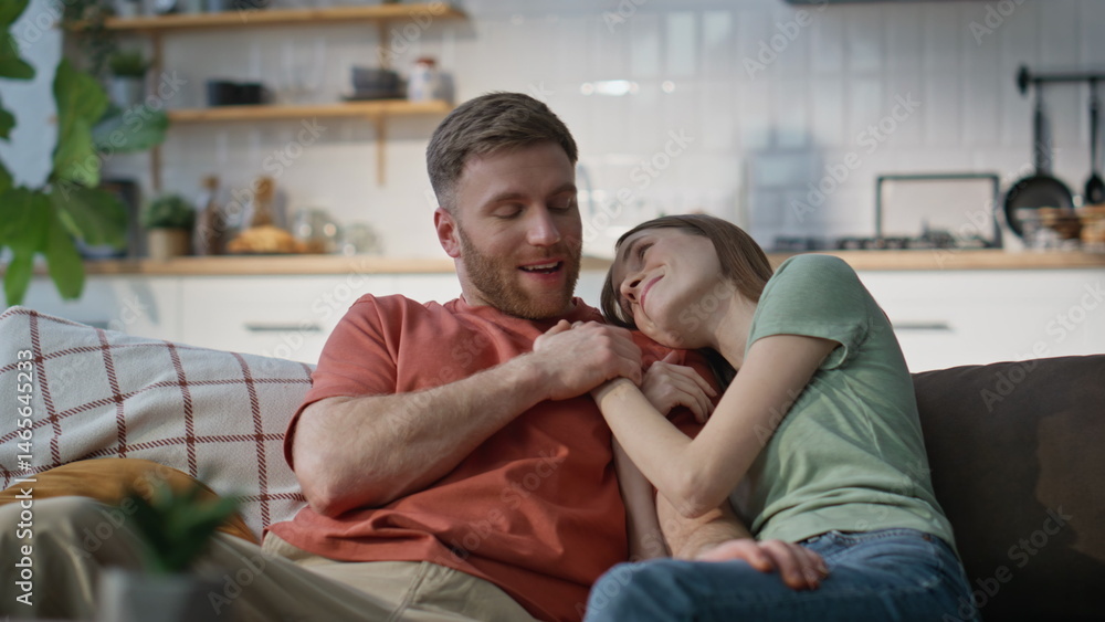 Married couple cuddling couch enjoying domestic atmosphere closeup. Joyful pair