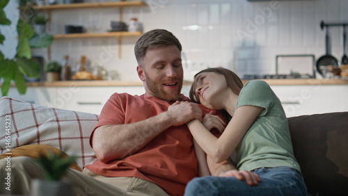 Obraz na płótnie Married couple cuddling couch enjoying domestic atmosphere closeup. Joyful pair w salonie