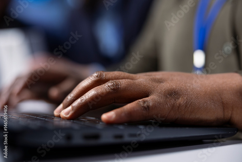 Solar panel manufacturing plant researcher typing on laptop keyboard, developing new solar energy systems prototypes. Factory expert researching innovative photovoltaics materials on notebook, close