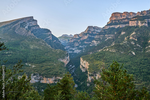 A landscape of the Cañon de Añisclo valley, with high rocky mountains, green forests. in Ordesa natural park, Huesca, Aragon, Spain
