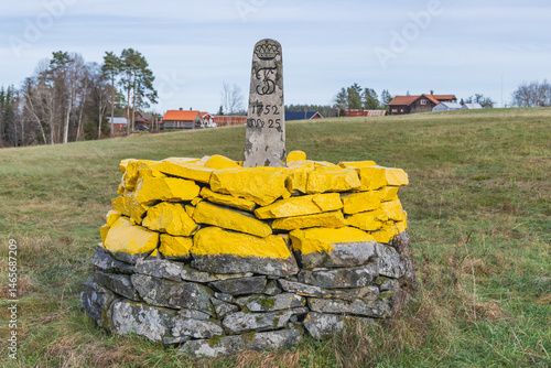 Obraz na płótnie Cairn marking the border between Norway and Sweden on a rural road near Bastnas. w salonie