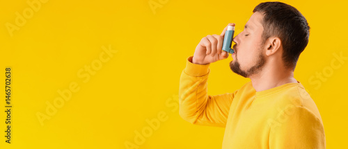 Sick man with inhaler on ye...