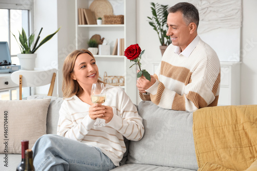 Mature couple with glass of...