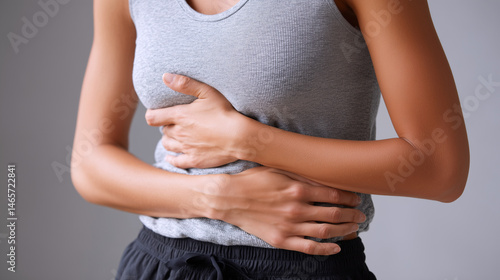 Young woman experiencing stomach cramps
