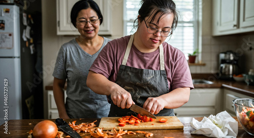 Woman with down syndrome cutting tomatoes while cooking with her mother