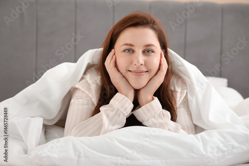 Beautiful young woman lying...
