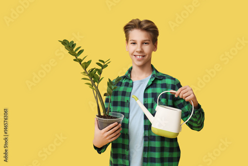 Teenage boy with plant and ...