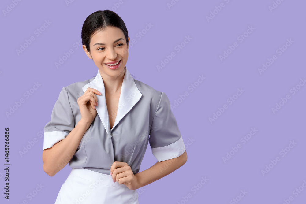Beautiful young chambermaid on purple background Beautiful young chambermaid on purple background