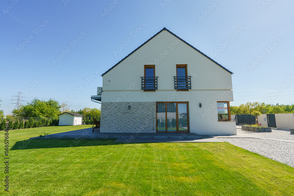 Side view of new build house with freshly cut grass