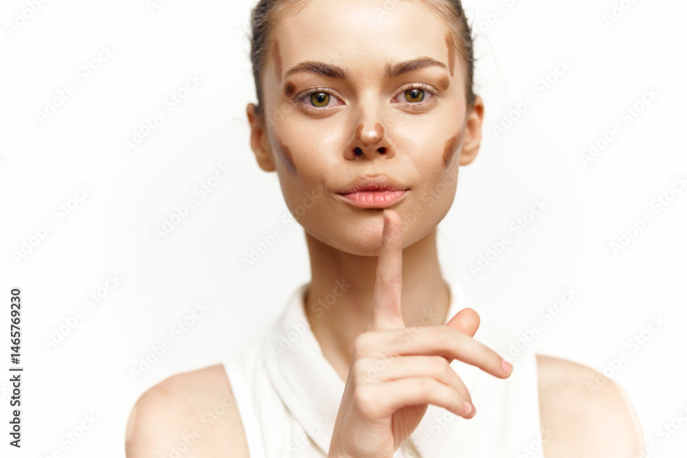 A serene model with a gentle expression and minimal makeup, wearing a white outfit, signaling silence against a bright background.