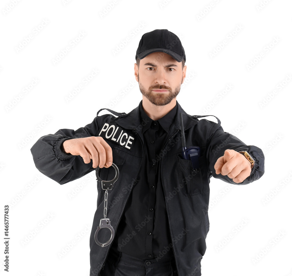 Male police officer with radio transmitter and handcuffs pointing at viewer on white background Male police officer with radio transmitter and handcuffs pointing at viewer on white background