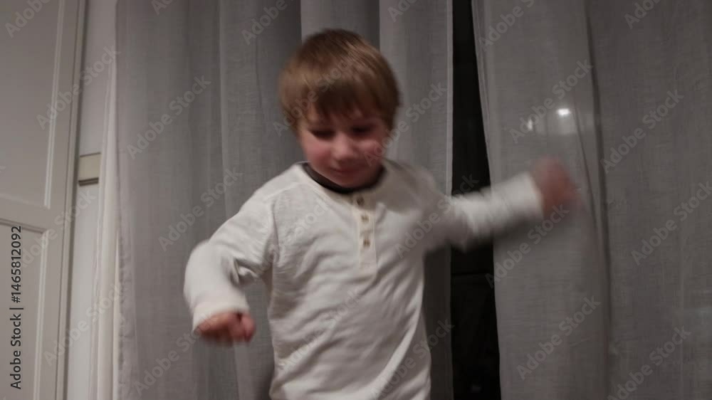Young boy dancing energetically in living room Young boy dancing energetically in living room