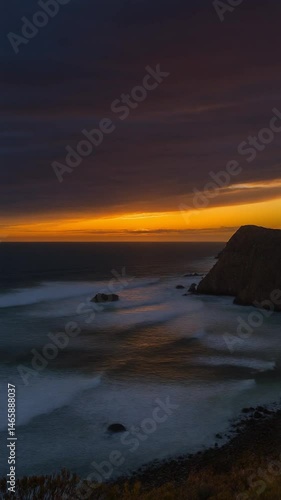 A timelapse of the sunset along a rocky coast. Ocean.
