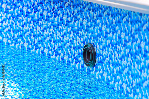 Obraz na plátne Bright blue mosaic design of pool liner reveals drainage opening in clear water