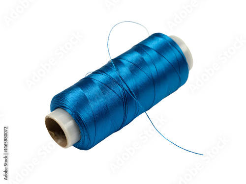 Close up shot of a vibrant teal blue spool of thread for sewing and crafting projects