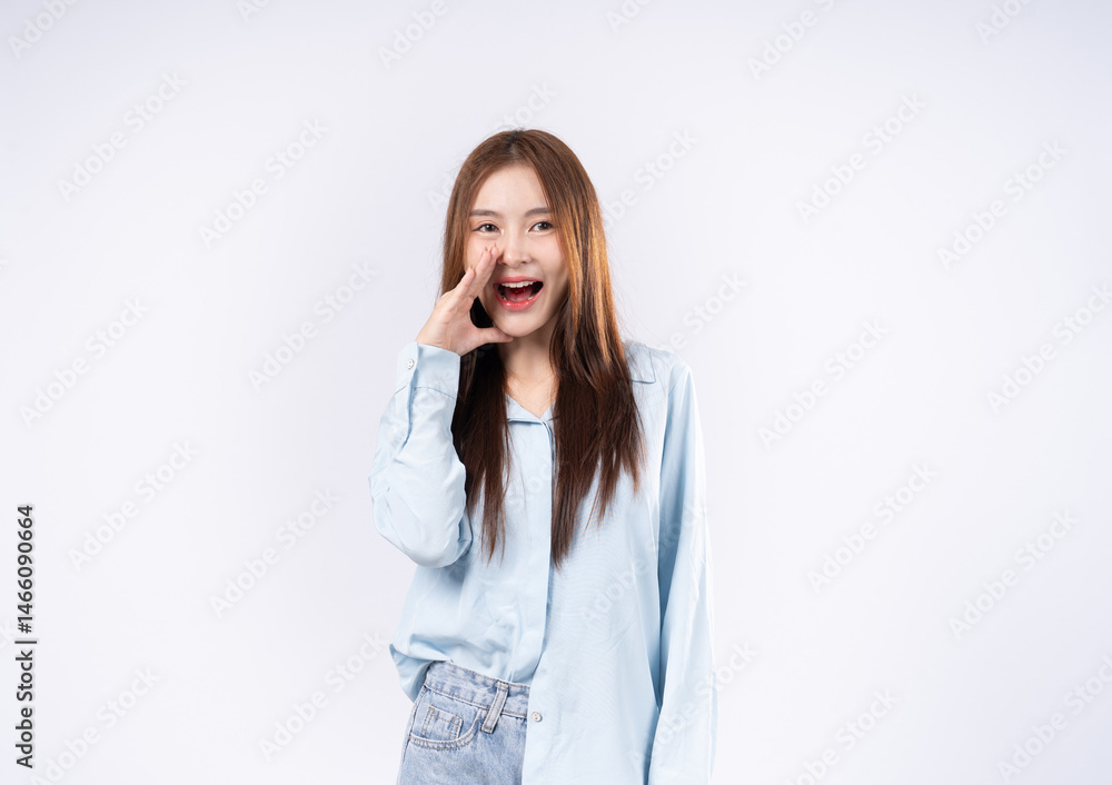 Portrait of a woman against a white background, covering her mouth with her hand and shouting loudly. Portrait of a woman against a white background, covering her mouth with her hand and shouting loudly.